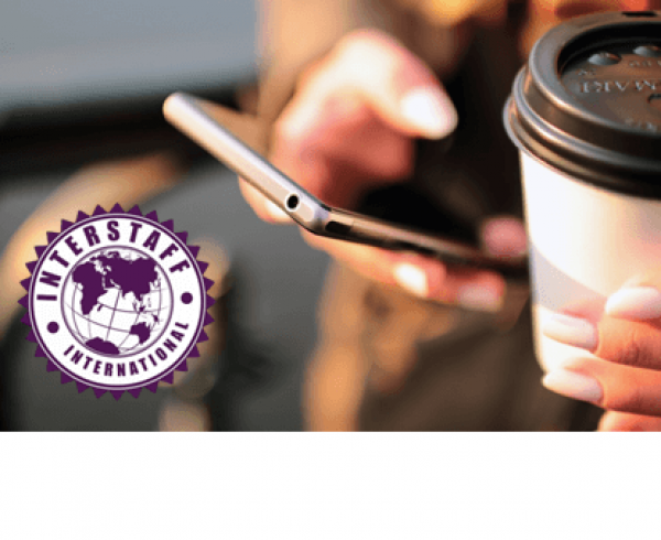 Woman holding her mobile phone and coffee cup with Interstaff International logo
