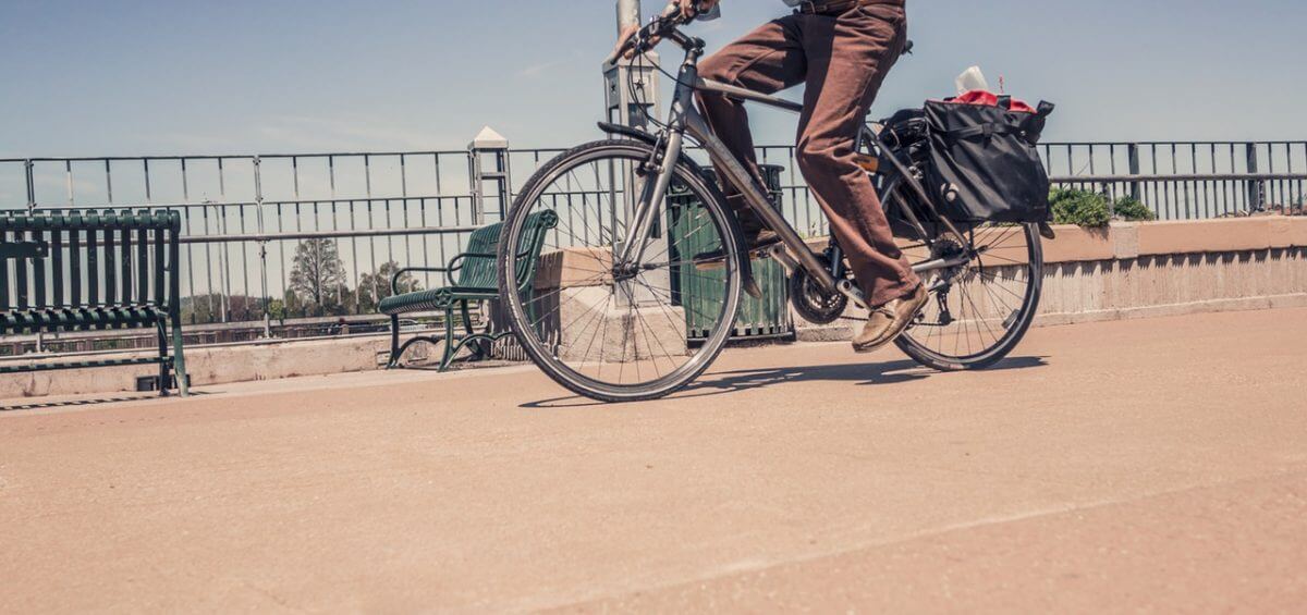Man cycling on a path during the summer