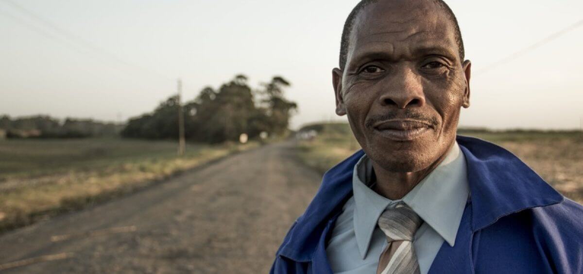 Closeup of ethnic man standing on road