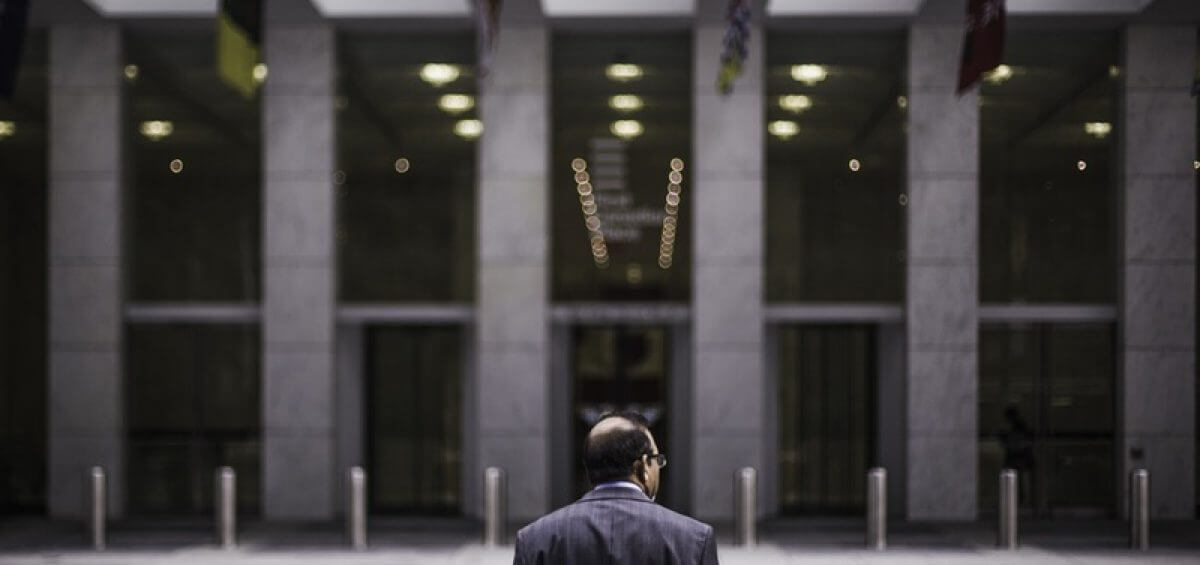 Man standing across from building
