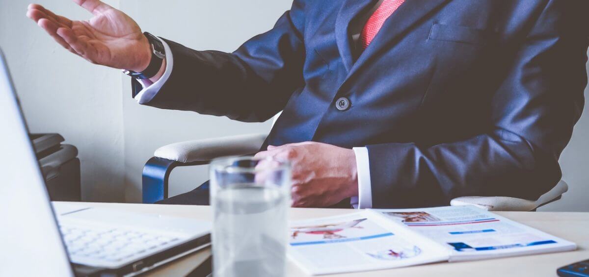 Businessman with his hand raised