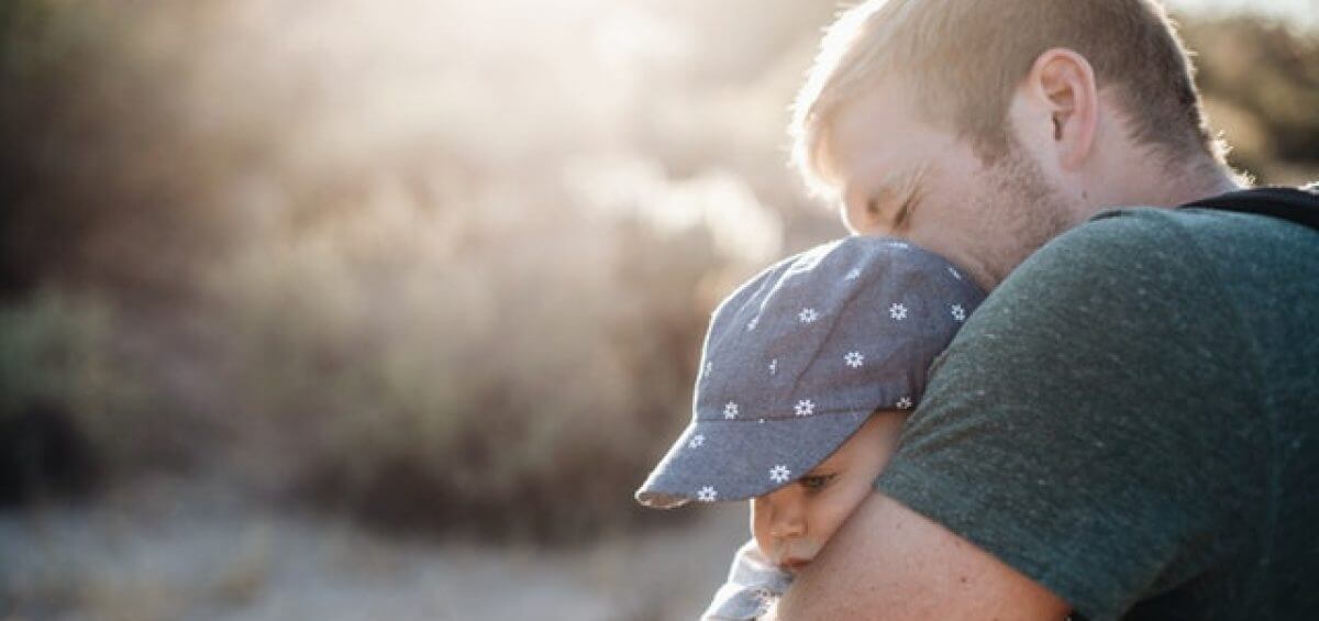 Young father hugging his child, happy about permanent residence in Australia