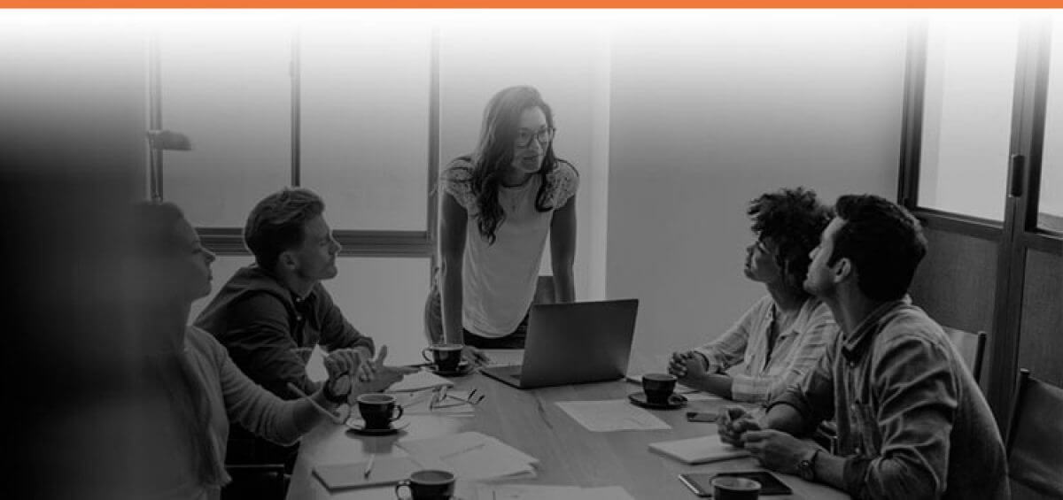 Boss talking to her employees with Interstaff orange top border for Permanent Work Visas service