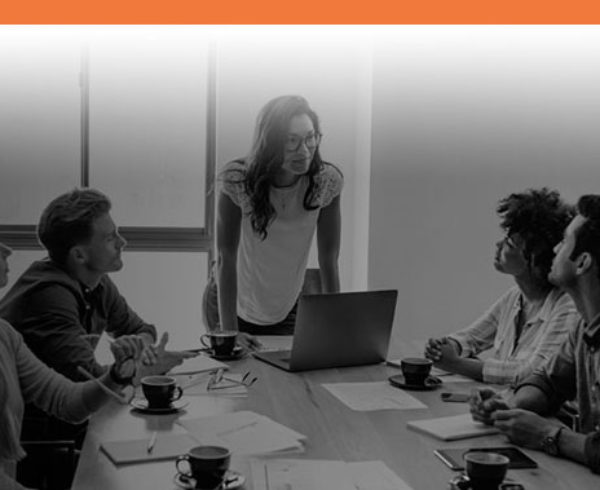 Boss talking to her employees with Interstaff orange top border for Permanent Work Visas service