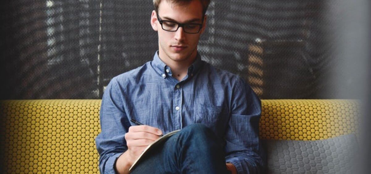 Young entrepreneur writing about his startup