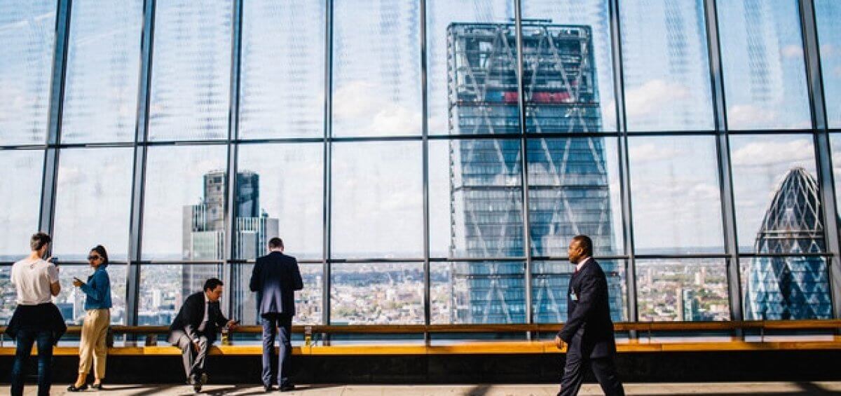 A business man walking through a building thinking about changing sponsors