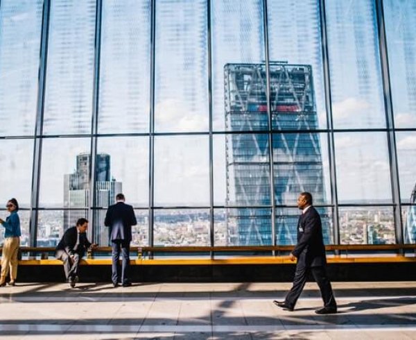 A business man walking through a building thinking about changing sponsors