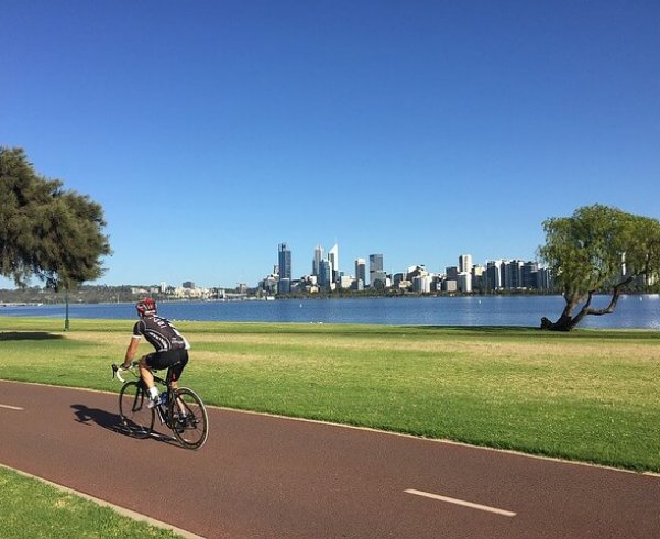 Man cycling in Perth, one of the top 10 most liveable cities