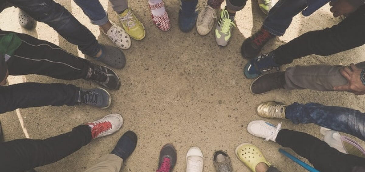 People standing in a circle to represent population growth