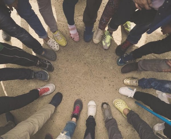 People standing in a circle to represent population growth