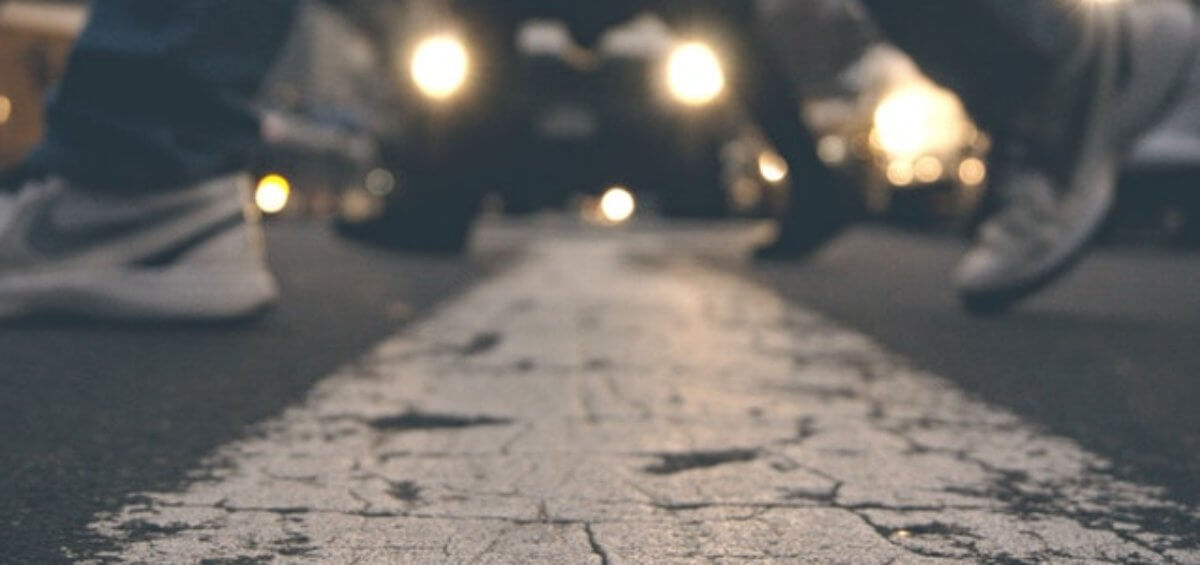 Two people walking across cross walk