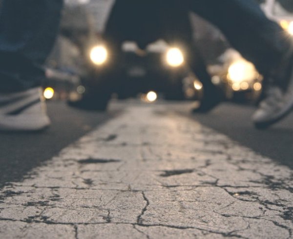 Two people walking across cross walk