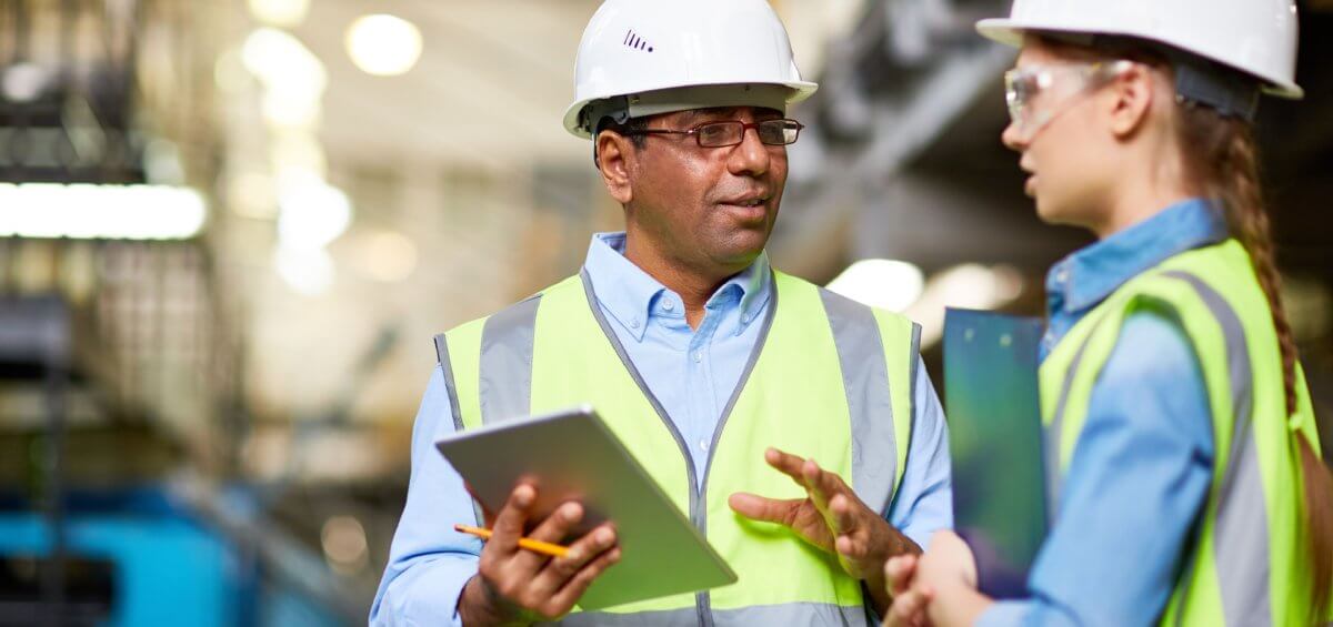 Two high-vis inspectors doing through checklist of work activities