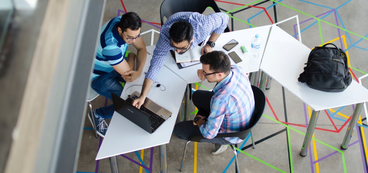Group of workers discussing the Skilled Occupation List in 2020 in open workspace