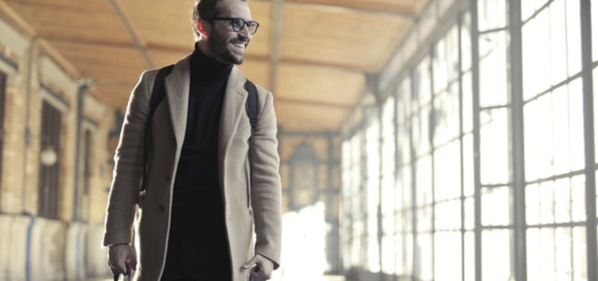 Young man with Australia passport carrying bags of luggage