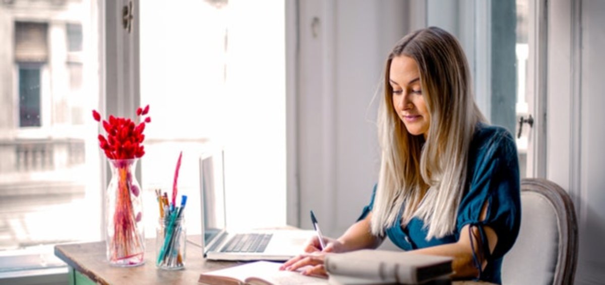 Woman at desk researching support for temporary visa holders in Australia